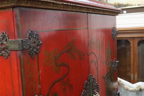 A red lacquer cocktail cabinet on stand, W.105cm